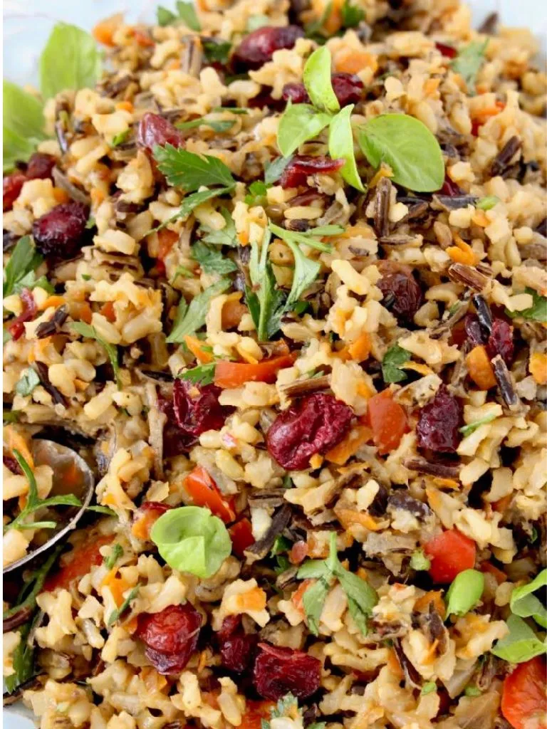 A colorful wild rice pilaf with dried cherries served in a bowl, showcasing a mix of textures and flavors.